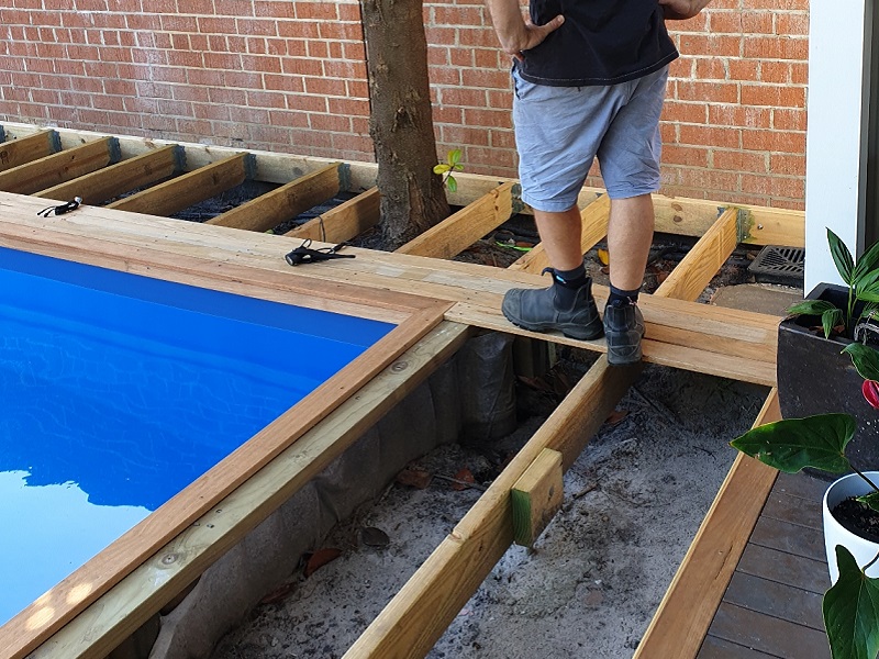 pool decking laid on pools top coping